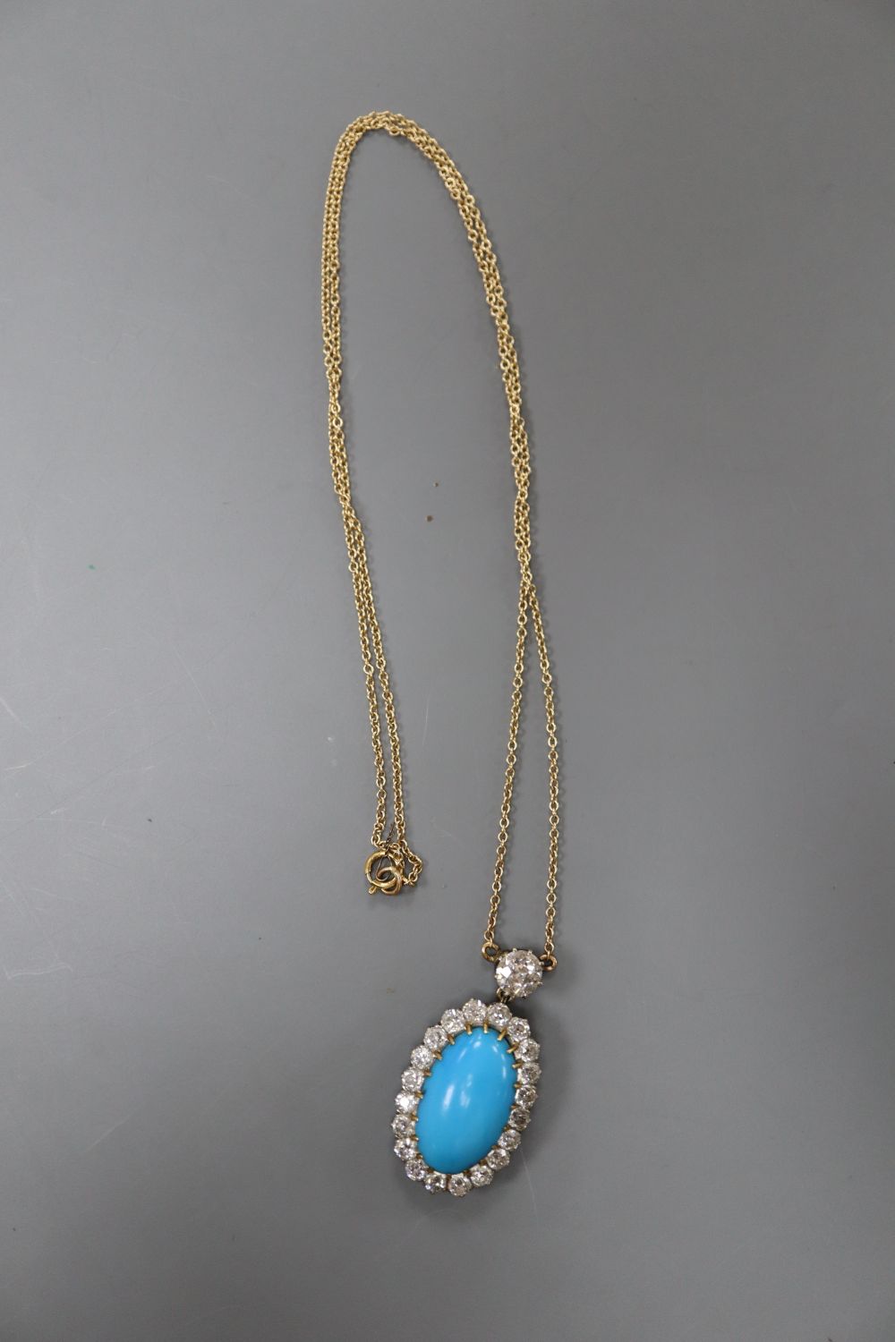 A yellow metal, turquoise and diamond set oval pendant necklace, pendant 3cm, gross 6 grams,